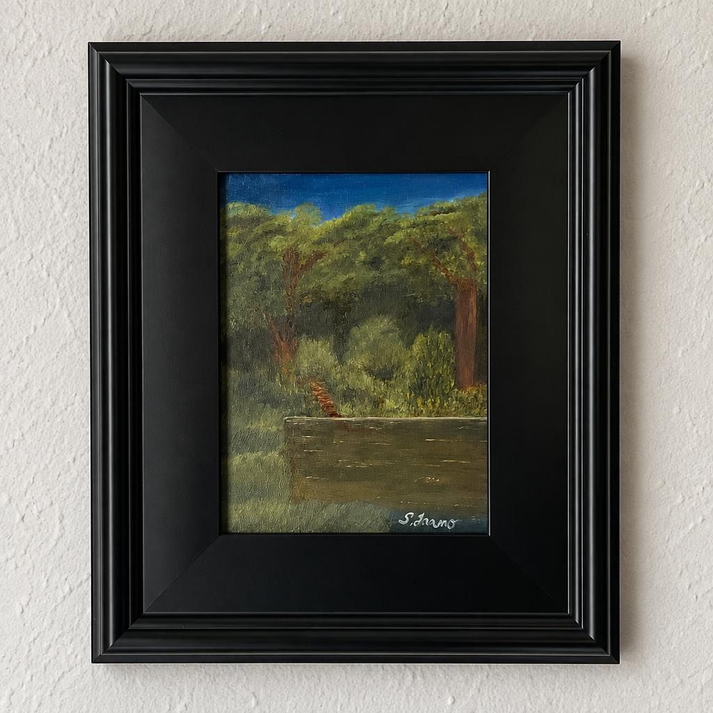 Original landscape oil painting in a black plein air frame hanging on a textured white wall.